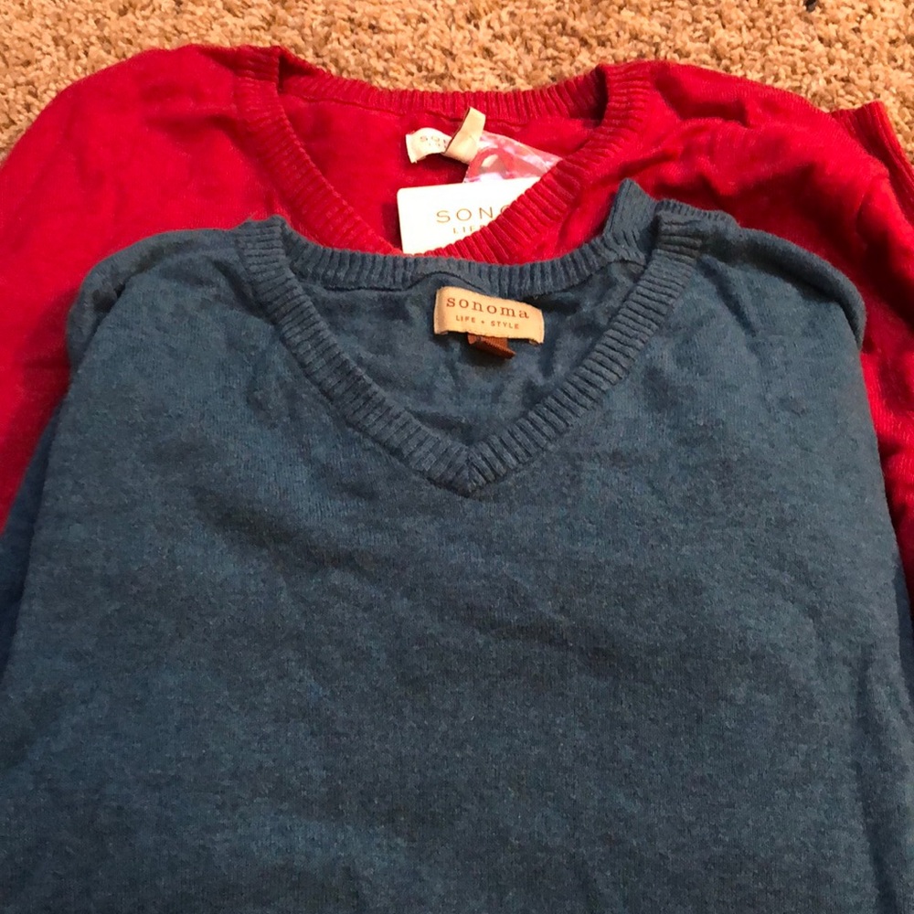 Two men’s sweaters